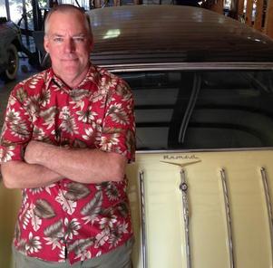 David Kugle in a Hawaiian shirt next to a classic vintage car